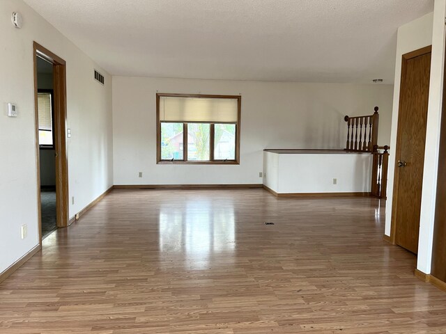 310 8th St, Windom, MN 56101 - spare room with wood finished floors, baseboards, and a smoke detector