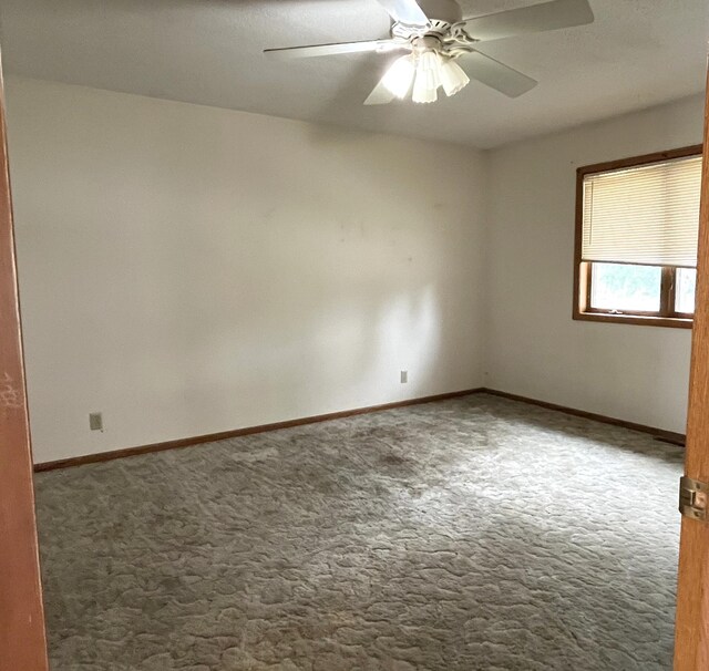 310 8th St, Windom, MN 56101 - empty room featuring carpet, a ceiling fan, and baseboards