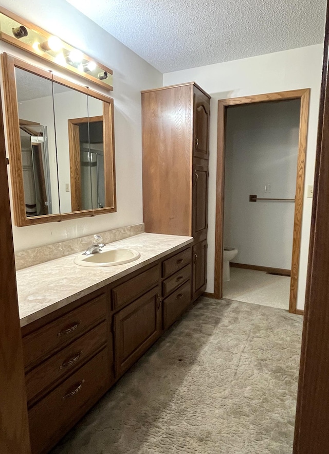 310 8th St, Windom, MN 56101 - bathroom with vanity, a textured ceiling, and toilet