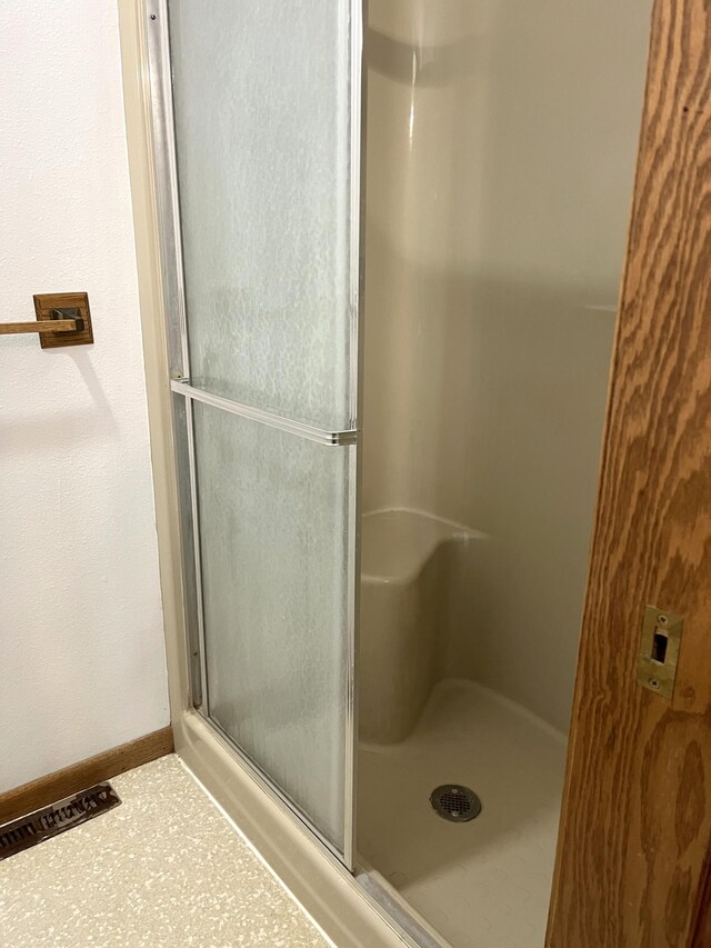 310 8th St, Windom, MN 56101 - full bath featuring a stall shower and baseboards