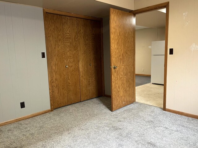310 8th St, Windom, MN 56101 - unfurnished bedroom featuring freestanding refrigerator, carpet flooring, baseboards, and a closet