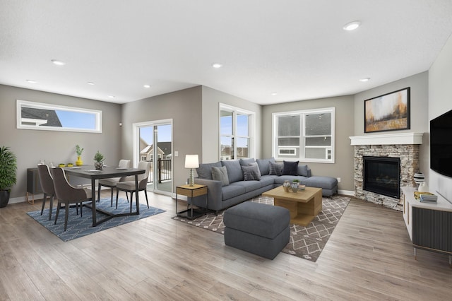 7657 Swan St, Lino Lakes, MN 55038 - living area with baseboards, light wood finished floors, a fireplace, and recessed lighting