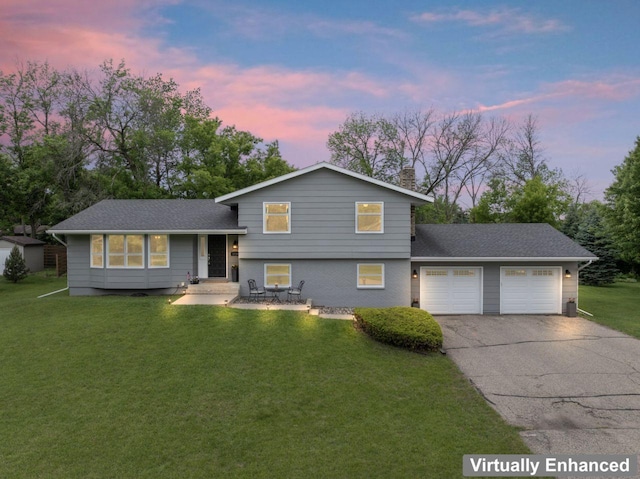 1719 Buckingham Path, Faribault, MN 55021 - tri-level home featuring an attached garage, a lawn, driveway, and roof with shingles