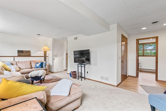 1719 Buckingham Path, Faribault, MN 55021 - carpeted living room with a drop ceiling, baseboards, and a baseboard radiator