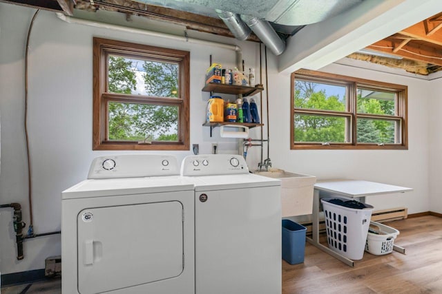1719 Buckingham Path, Faribault, MN 55021 - laundry room featuring washer and clothes dryer, a baseboard radiator, and light wood finished floors