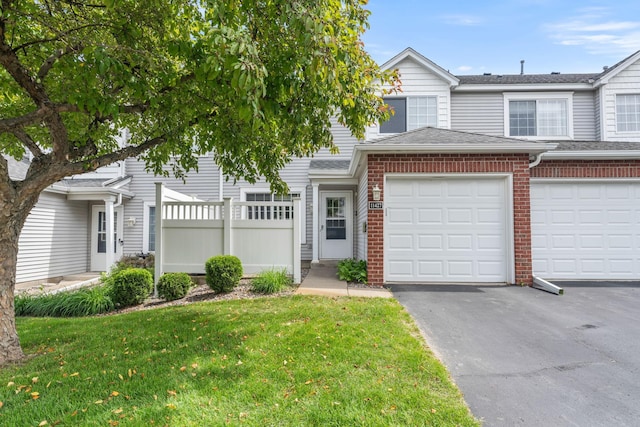 11427 Elmwood Ave N, Champlin, MN 55316 - townhome / multi-family property featuring brick siding, asphalt driveway, an attached garage, and roof with shingles