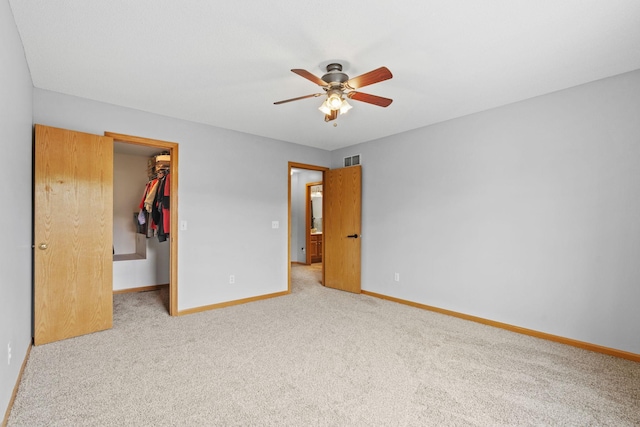 11427 Elmwood Ave N, Champlin, MN 55316 - unfurnished bedroom featuring a spacious closet, carpet floors, a closet, and a ceiling fan