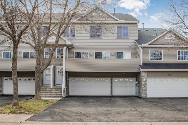 11167 16th St NE, Saint Michael, MN 55376 - townhome / multi-family property featuring driveway, a garage, and a shingled roof