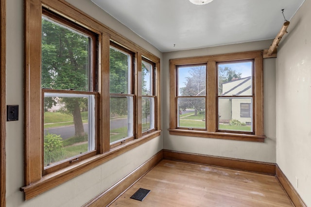 4129 7th St NE, Columbia Heights, MN 55421 - unfurnished sunroom with wood finished floors and baseboards
