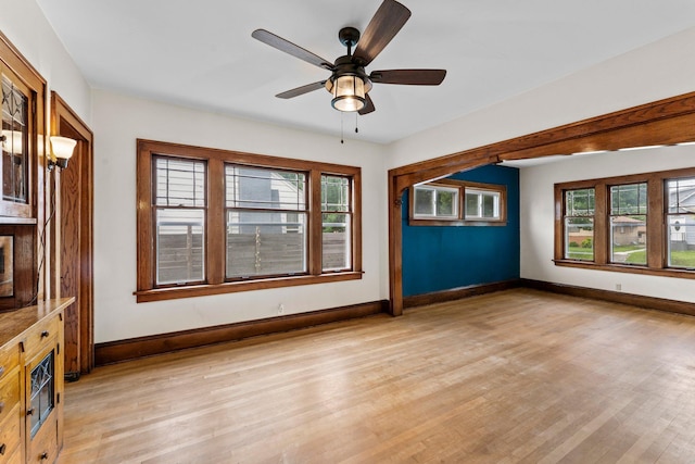 4129 7th St NE, Columbia Heights, MN 55421 - unfurnished living room featuring healthy amount of natural light, light wood finished floors, and a ceiling fan