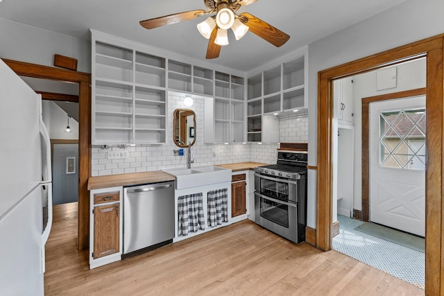 4129 7th St NE, Columbia Heights, MN 55421 - kitchen featuring appliances with stainless steel finishes, open shelves, wood counters, and decorative backsplash