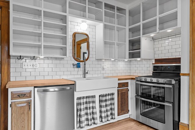 4129 7th St NE, Columbia Heights, MN 55421 - kitchen featuring appliances with stainless steel finishes, butcher block counters, backsplash, and open shelves