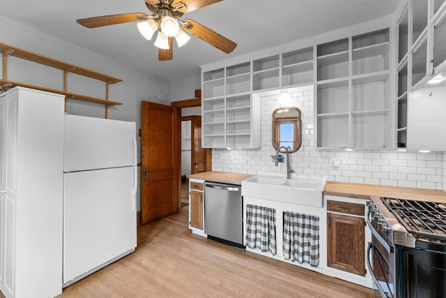 4129 7th St NE, Columbia Heights, MN 55421 - kitchen with open shelves, appliances with stainless steel finishes, butcher block counters, ceiling fan, and tasteful backsplash