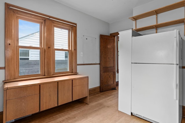 4129 7th St NE, Columbia Heights, MN 55421 - kitchen with freestanding refrigerator, light wood-style floors, and light countertops