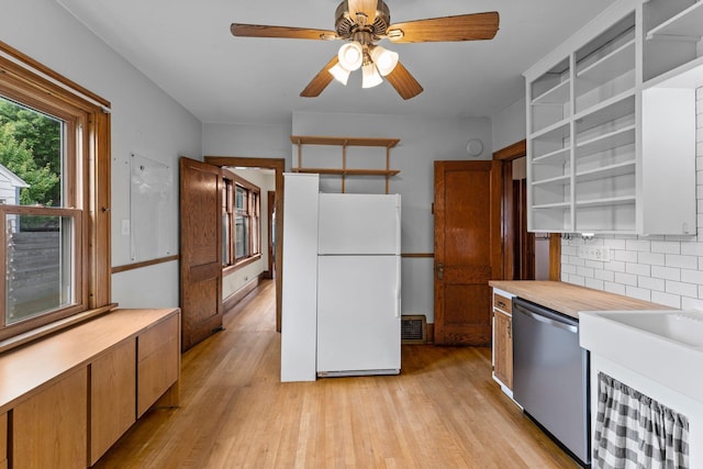 4129 7th St NE, Columbia Heights, MN 55421 - kitchen featuring freestanding refrigerator, stainless steel dishwasher, open shelves, decorative backsplash, and light wood finished floors