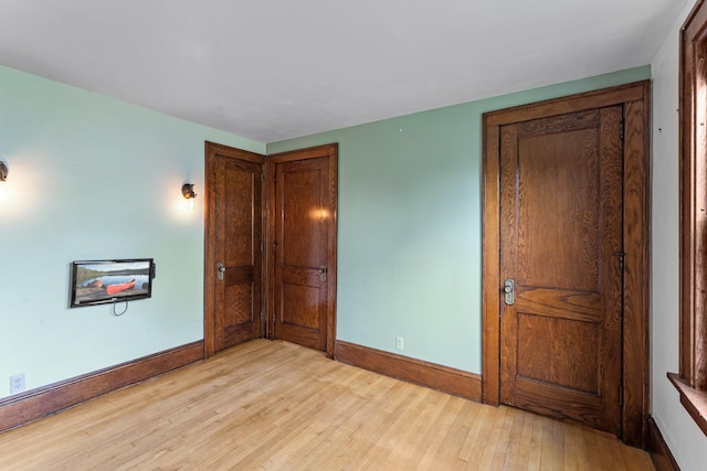 4129 7th St NE, Columbia Heights, MN 55421 - unfurnished bedroom featuring baseboards and light wood-style flooring