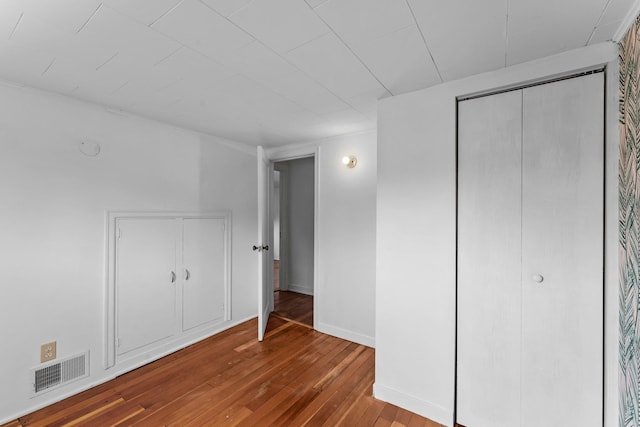 4129 7th St NE, Columbia Heights, MN 55421 - unfurnished bedroom featuring hardwood / wood-style floors and baseboards