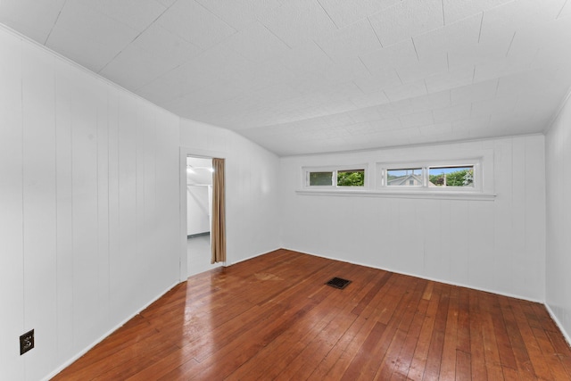 4129 7th St NE, Columbia Heights, MN 55421 - empty room with hardwood / wood-style flooring and vaulted ceiling