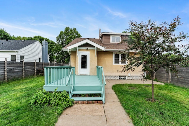 4129 7th St NE, Columbia Heights, MN 55421 - view of front facade with a deck, a fenced backyard, stucco siding, and roof with shingles