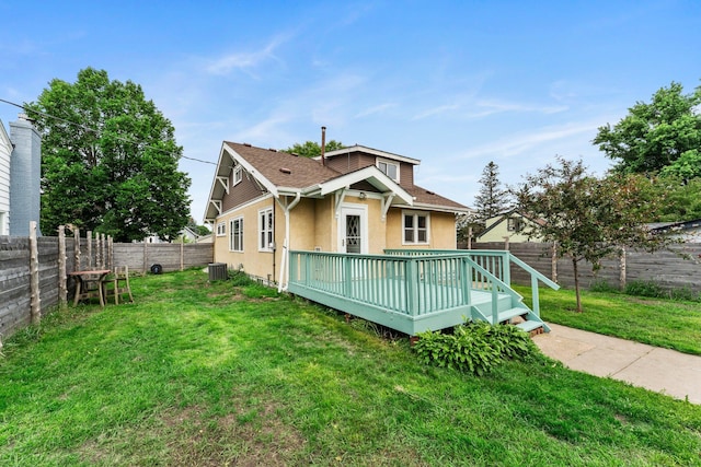 4129 7th St NE, Columbia Heights, MN 55421 - back of house with stucco siding, a fenced backyard, a wooden deck, and roof with shingles