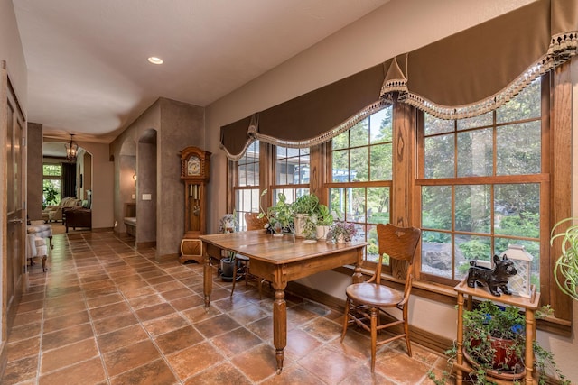 56273 185th Ln, Rapidan Twp, MN 56037 - dining space featuring arched walkways, stone finish flooring, recessed lighting, and baseboards