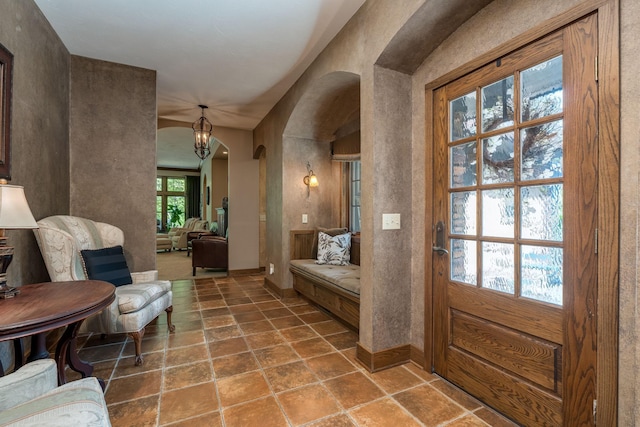 56273 185th Ln, Rapidan Twp, MN 56037 - foyer with arched walkways, baseboards, a chandelier, and stone finish flooring