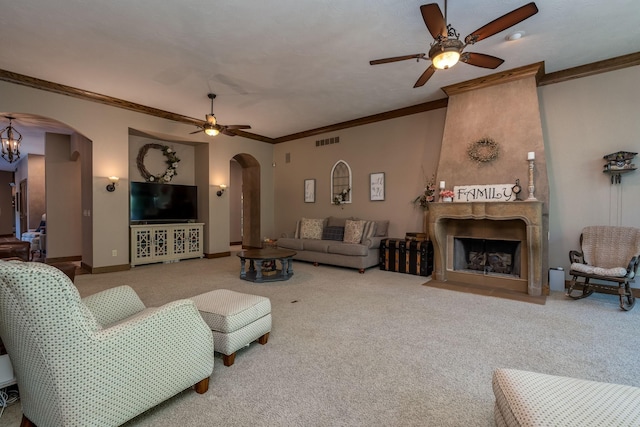 56273 185th Ln, Rapidan Twp, MN 56037 - living room with arched walkways, ceiling fan, carpet flooring, crown molding, and a large fireplace