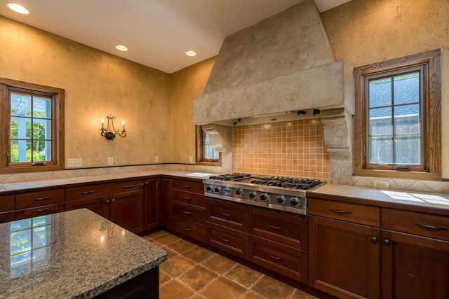 56273 185th Ln, Rapidan Twp, MN 56037 - kitchen with stainless steel gas stovetop, premium range hood, decorative backsplash, recessed lighting, and dark tile patterned floors