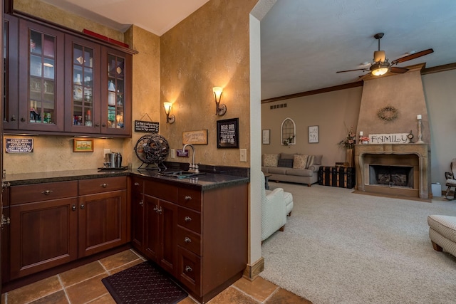 56273 185th Ln, Rapidan Twp, MN 56037 - kitchen featuring dark countertops, open floor plan, ceiling fan, glass insert cabinets, and ornamental molding