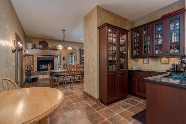 56273 185th Ln, Rapidan Twp, MN 56037 - bar featuring baseboards, a textured wall, a sink, decorative light fixtures, and dark stone finish flooring