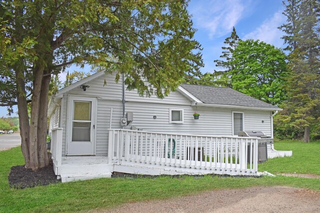 630 Oak St, Crosby, MN 56441 - rear view of property featuring a deck, roof with shingles, and a lawn