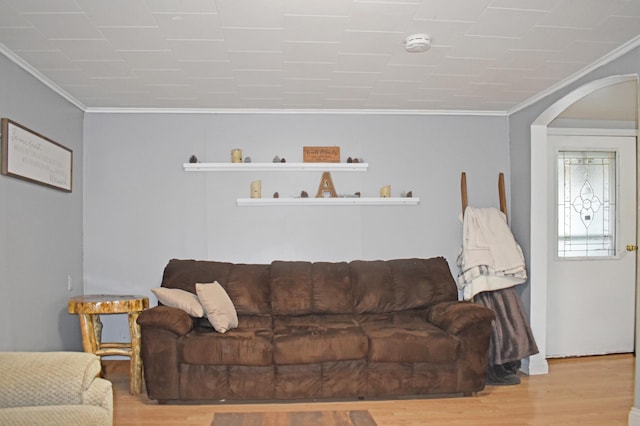 630 Oak St, Crosby, MN 56441 - living area featuring ornamental molding, arched walkways, and wood finished floors