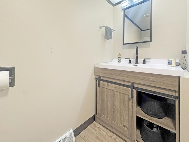 630 Oak St, Crosby, MN 56441 - bathroom featuring wood finished floors, vanity, and baseboards