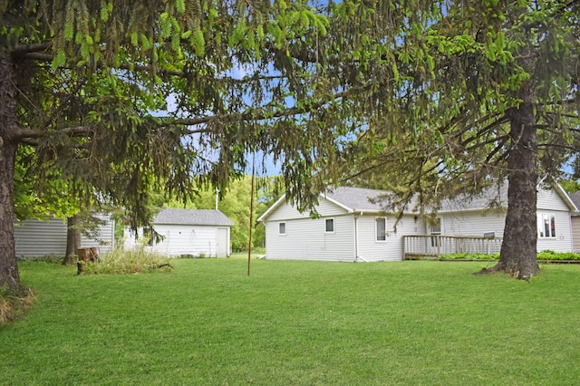 630 Oak St, Crosby, MN 56441 - view of green lawn with a wooden deck and an outdoor structure