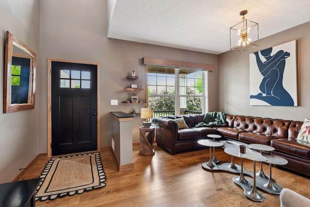 2392 Molnau Ct, Chaska, MN 55318 - foyer featuring wood finished floors, a chandelier, a textured ceiling, and baseboards