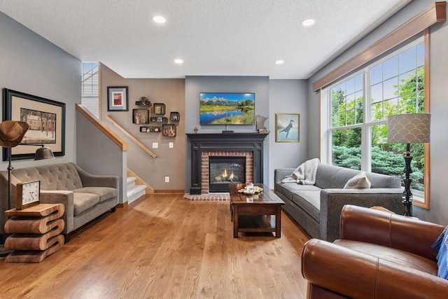 2392 Molnau Ct, Chaska, MN 55318 - living room with a textured ceiling, wood finished floors, stairway, a fireplace, and recessed lighting