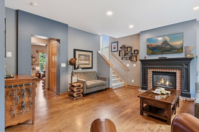 2392 Molnau Ct, Chaska, MN 55318 - living room with wood finished floors, a fireplace, baseboards, stairs, and recessed lighting