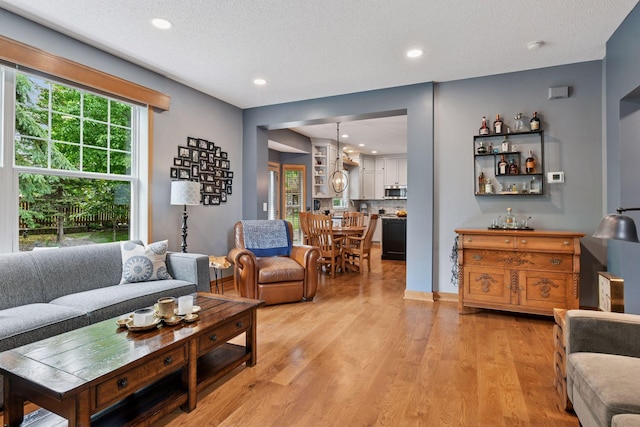 2392 Molnau Ct, Chaska, MN 55318 - living area featuring healthy amount of natural light, light wood-style floors, recessed lighting, and a textured ceiling