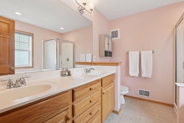 2392 Molnau Ct, Chaska, MN 55318 - bathroom with a shower stall, toilet, double vanity, and recessed lighting