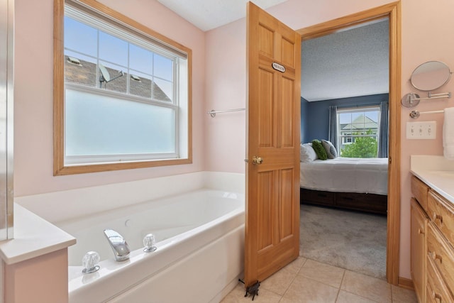 2392 Molnau Ct, Chaska, MN 55318 - ensuite bathroom featuring vanity, a bath, and tile patterned floors