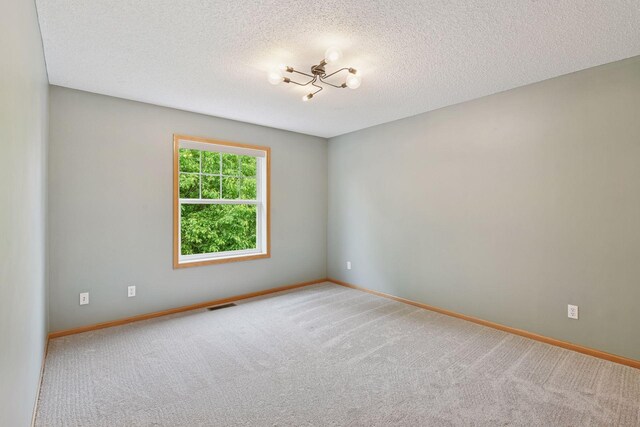 2392 Molnau Ct, Chaska, MN 55318 - carpeted empty room with a textured ceiling and baseboards