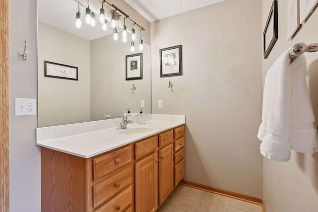2392 Molnau Ct, Chaska, MN 55318 - bathroom with vanity, a textured ceiling, tile patterned flooring, and baseboards