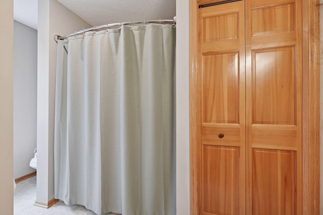 2392 Molnau Ct, Chaska, MN 55318 - bathroom featuring a textured ceiling, toilet, and curtained shower