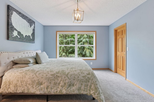 2392 Molnau Ct, Chaska, MN 55318 - bedroom featuring carpet floors, a chandelier, baseboards, and a textured ceiling