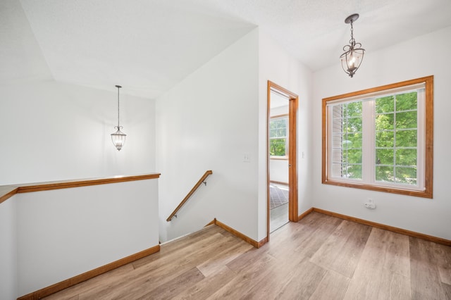 1106 Shumway Ct, Faribault, MN 55021 - entrance foyer featuring light wood-type flooring, a chandelier, baseboards, and vaulted ceiling