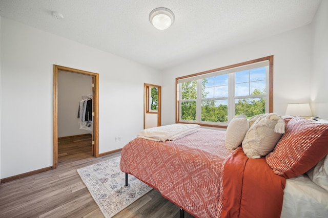1106 Shumway Ct, Faribault, MN 55021 - bedroom with baseboards, light wood-type flooring, and a spacious closet