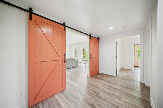 1106 Shumway Ct, Faribault, MN 55021 - spare room with a barn door, light wood-type flooring, baseboards, and recessed lighting