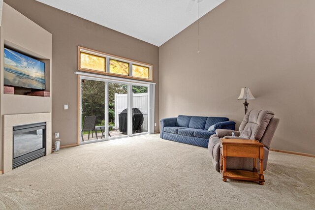 15440 Eminence Ave N Unit 2, Hugo, MN 55038 - living area with high vaulted ceiling, carpet floors, a glass covered fireplace, and baseboards