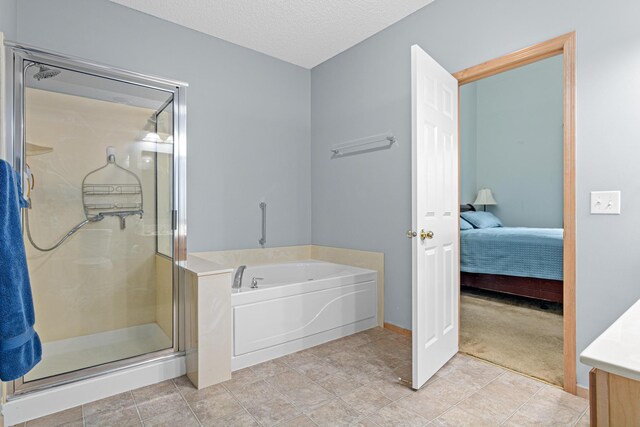 15440 Eminence Ave N Unit 2, Hugo, MN 55038 - full bath featuring a bath, a shower stall, vanity, connected bathroom, and a textured ceiling