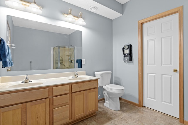 15440 Eminence Ave N Unit 2, Hugo, MN 55038 - bathroom featuring a shower stall, double vanity, baseboards, and toilet
